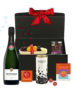 Personalised Taittinger Champagne Christmas hamper with chocolates, festive treats, and ribbon-tied gift box.