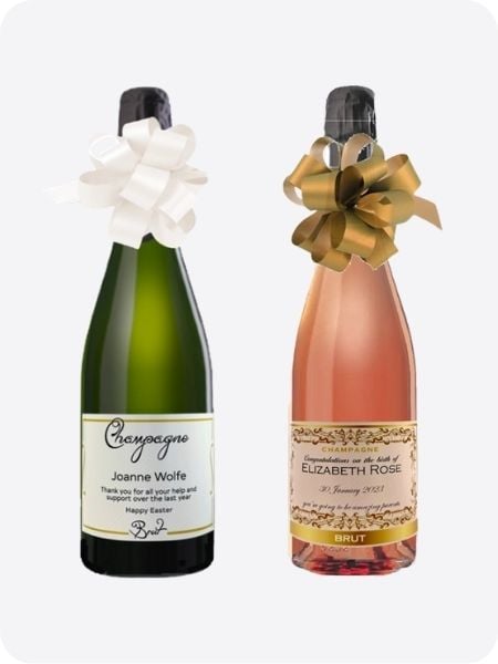 Personalised Champagne bottles with custom labels and hand-tied ribbon.